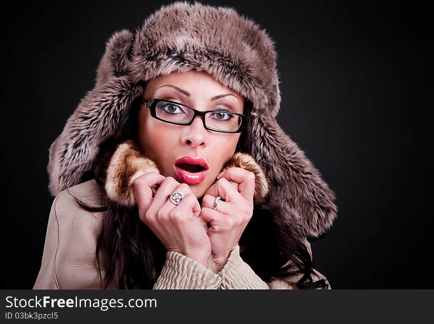 Attractive girl wear in warm winter fur hat