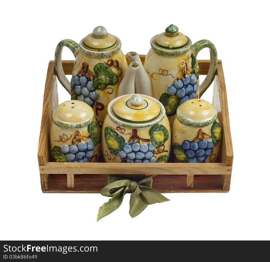 Isolated photo of a decorative table set. The set includes spice, pepper, salt, sugar, tea and milk cases. Isolated photo of a decorative table set. The set includes spice, pepper, salt, sugar, tea and milk cases.