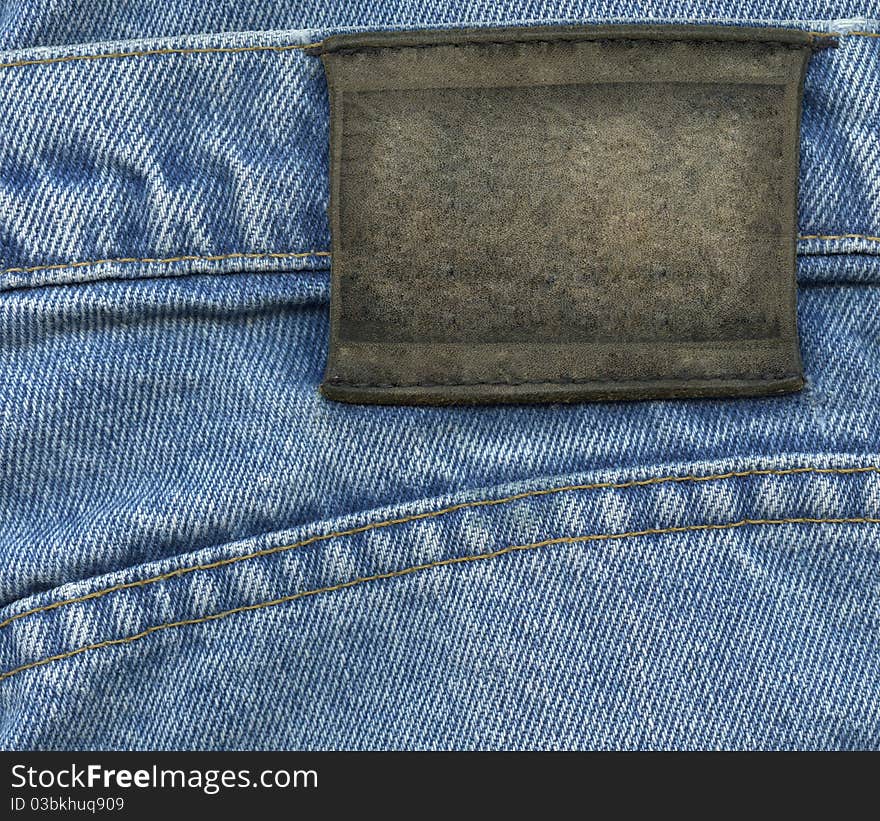 Blank leather label on blue jeans