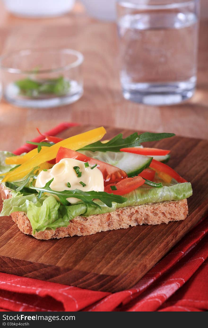 Slice of brown bread with fresh vegetables. Slice of brown bread with fresh vegetables