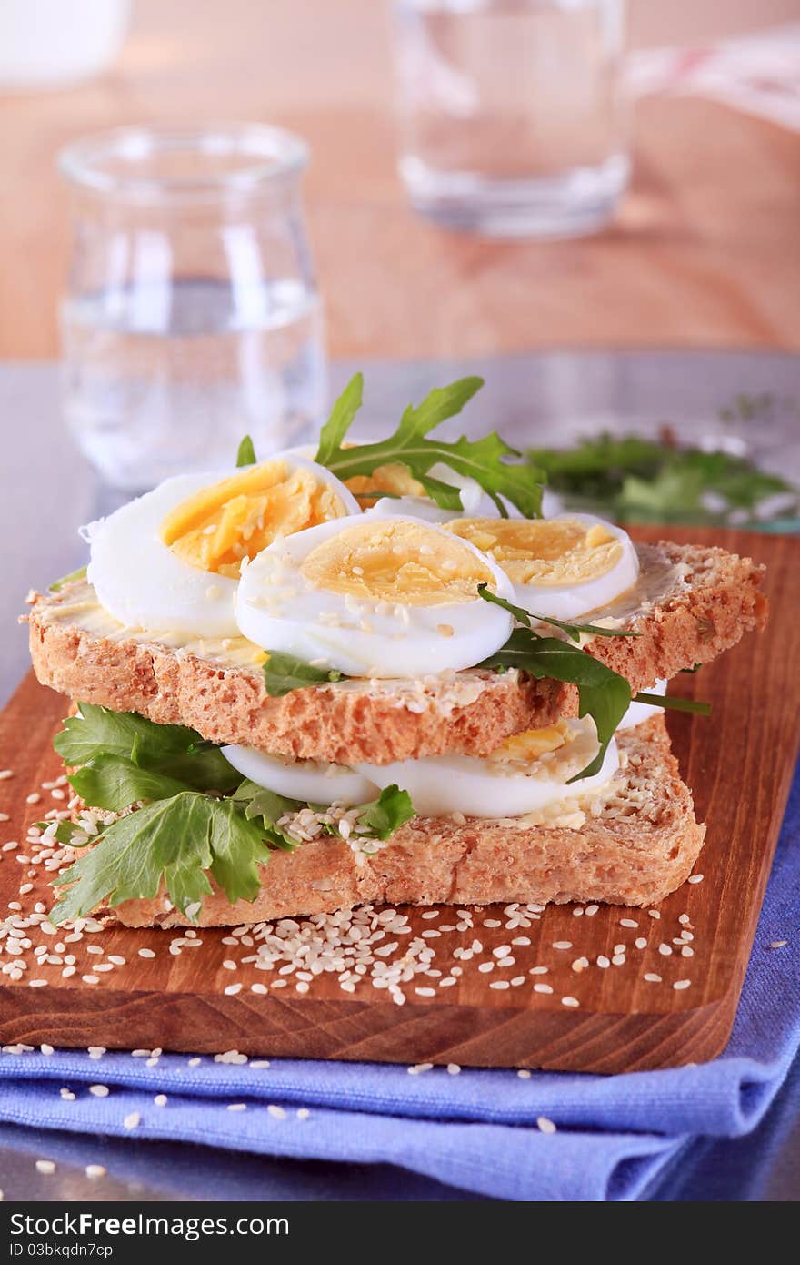 Whole wheat egg sandwich on a cutting board