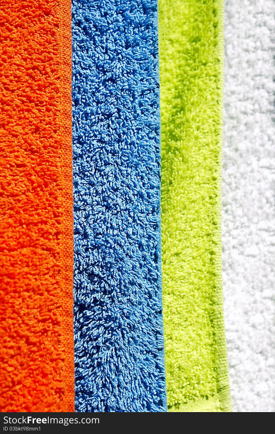 Four cotton towels drying in the sun. Four cotton towels drying in the sun