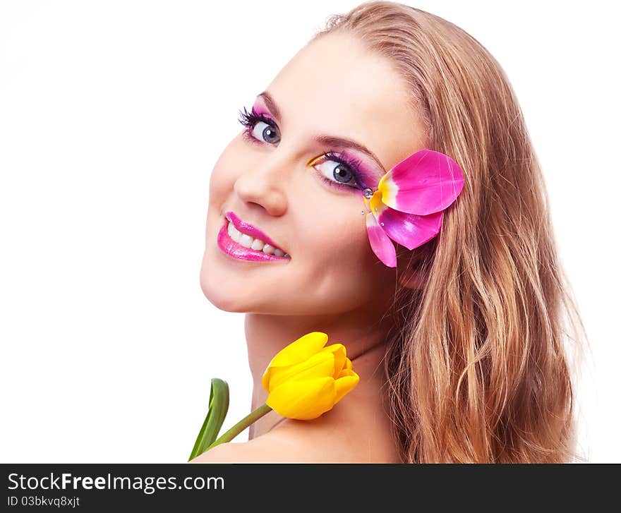 Beautiful young woman with a flower and creative makeup with tulip petals. Beautiful young woman with a flower and creative makeup with tulip petals