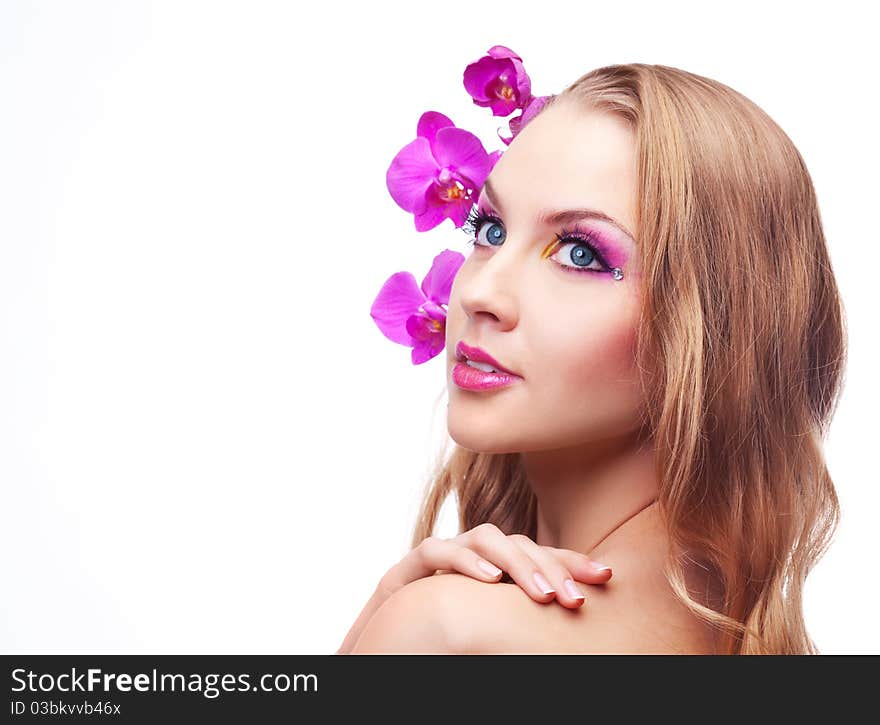 Beautiful young woman with long curly hair and an orchid. Beautiful young woman with long curly hair and an orchid