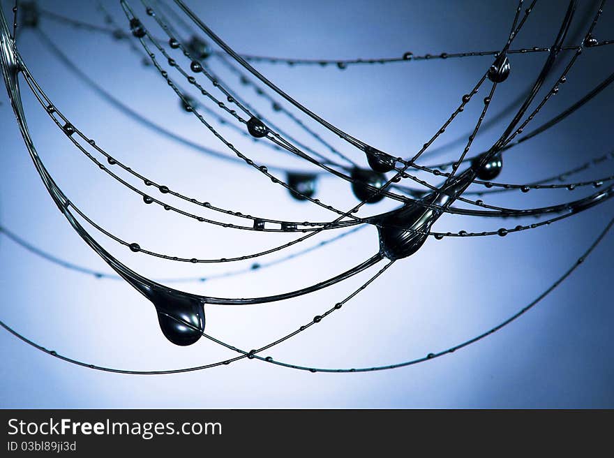 Black necklace and drops on blue background