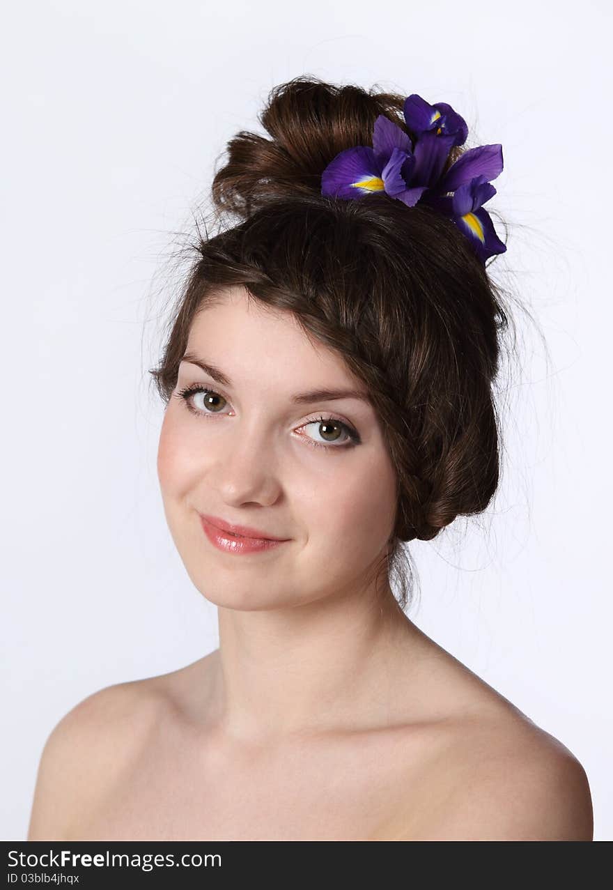 Portrait of the beauty young brunette girl with iris in her hair