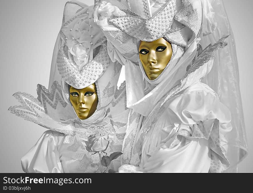 Woman and man with silver dress in the carnival of Venice, Italy.