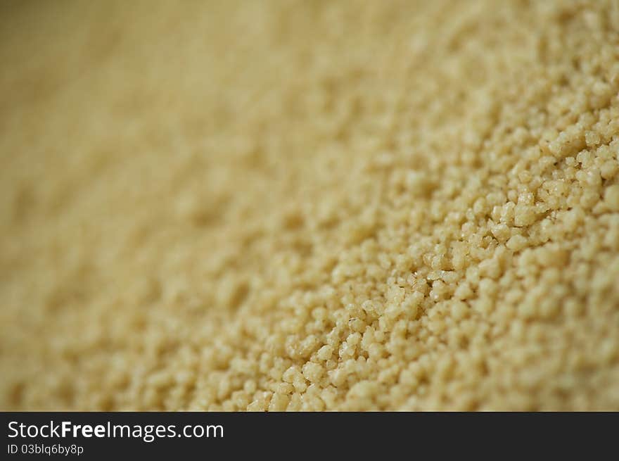 Macro photo of bulk uncooked couscous