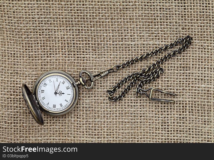 Pocket watch on burlap hessian