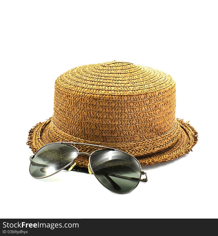 Straw hat and sunglasses isolated on a white background