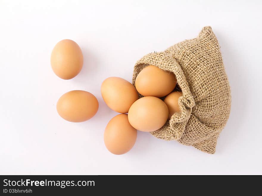 Brown eggs in canvas sack isolated on a white background