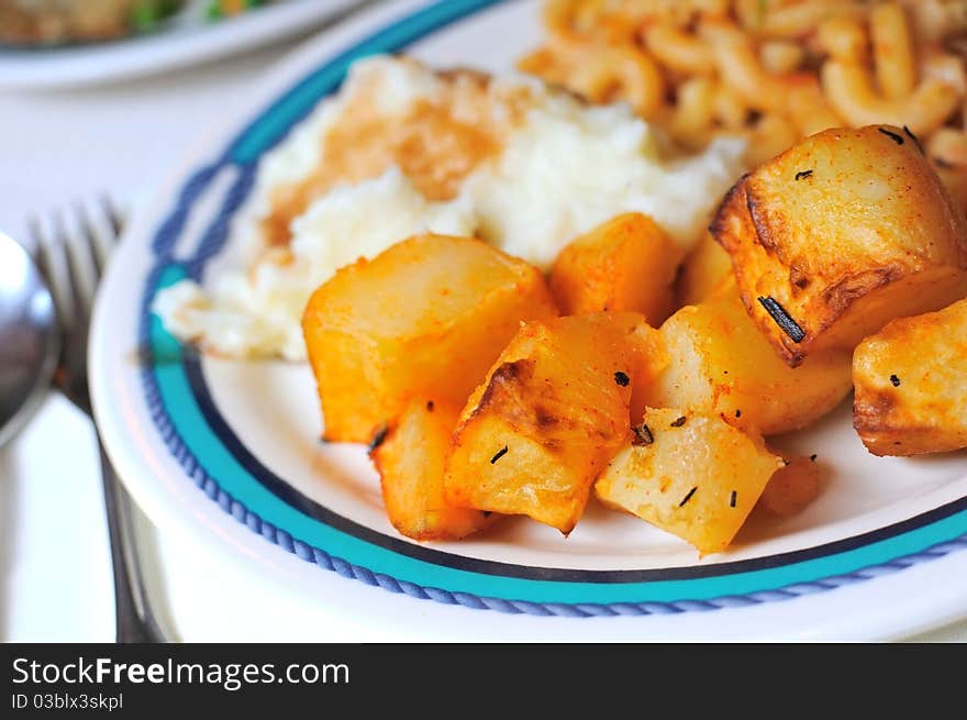 Seasoned and grilled tasty potatos served on white dish. Seasoned and grilled tasty potatos served on white dish.