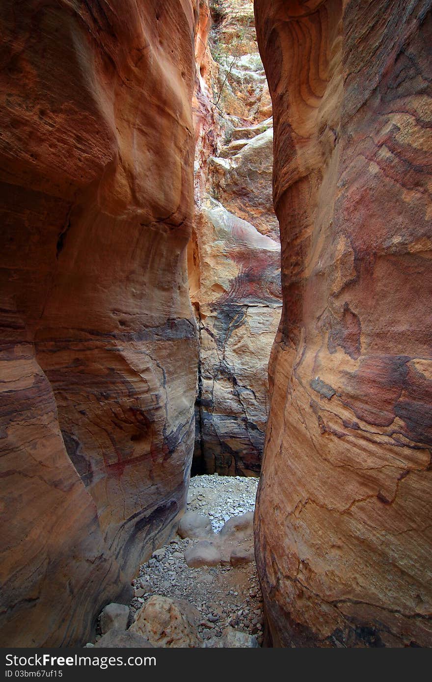 Interesting pathway through a narrow river valley that acts as a trekking trail through a quieter part of the ancient city of Petra. Interesting pathway through a narrow river valley that acts as a trekking trail through a quieter part of the ancient city of Petra.