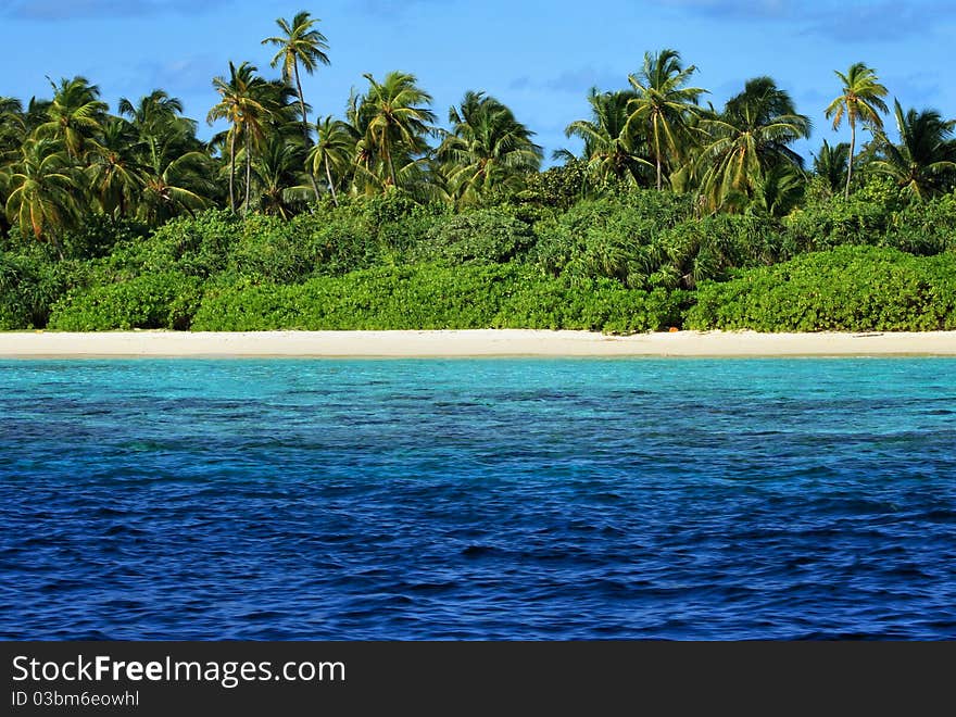 View towards the tempting beach and blue waters around the tropical island in Maldives. View towards the tempting beach and blue waters around the tropical island in Maldives.