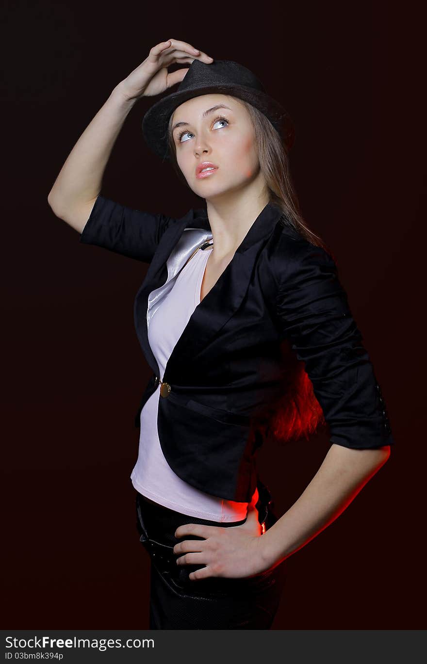 Woman with open lips in black hat on dark background