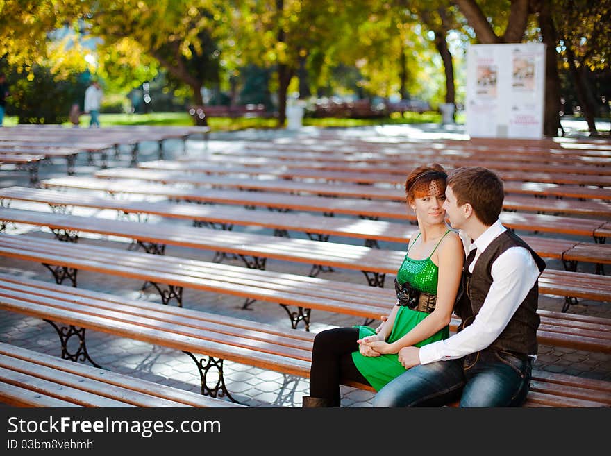 Shot of young Couple Sitting Together On Park Bench