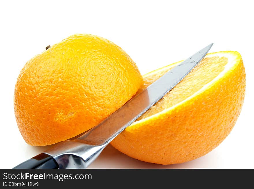 Knife and orange on a white background