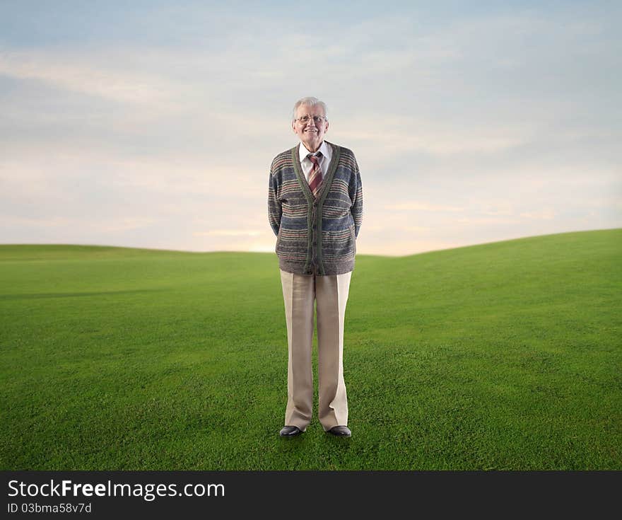 Smiling senior man on a green meadow. Smiling senior man on a green meadow