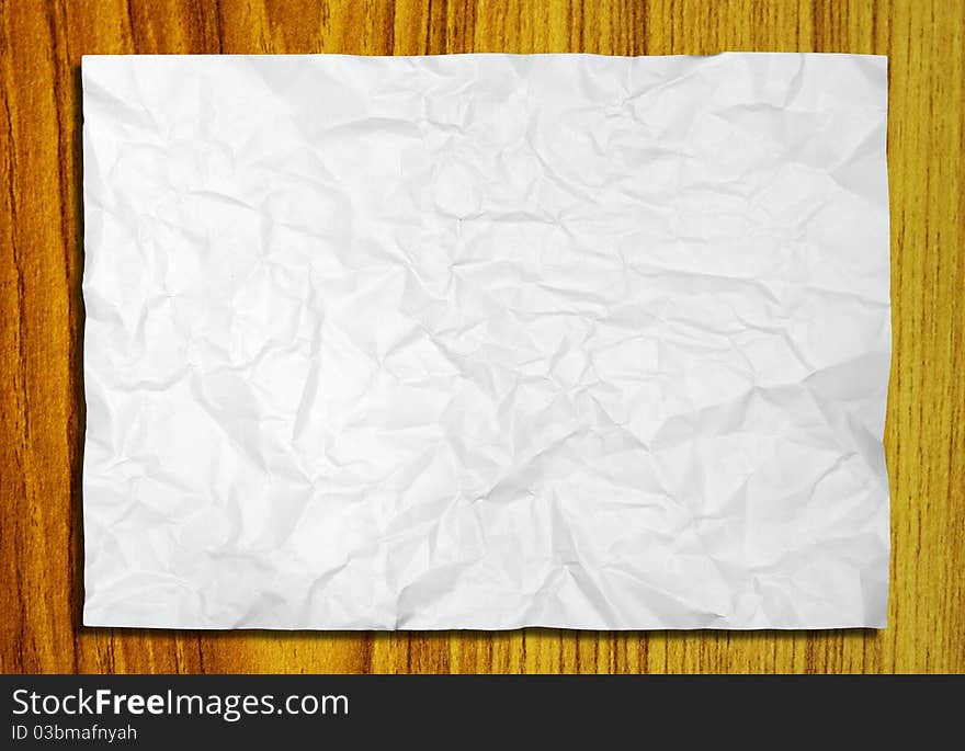 White crumpled paper on wood