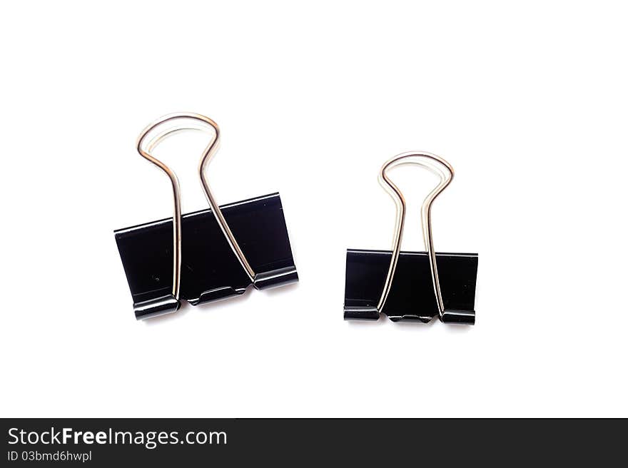 An image of black paper clips on white