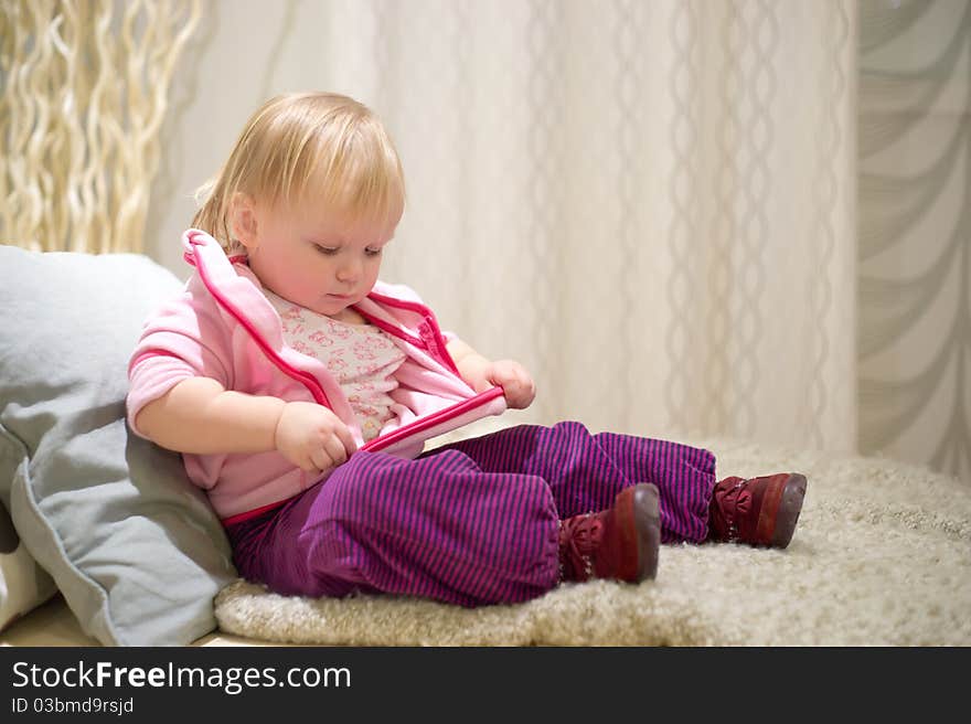 Young adorable baby preparing to sleep on sofa in bedroom