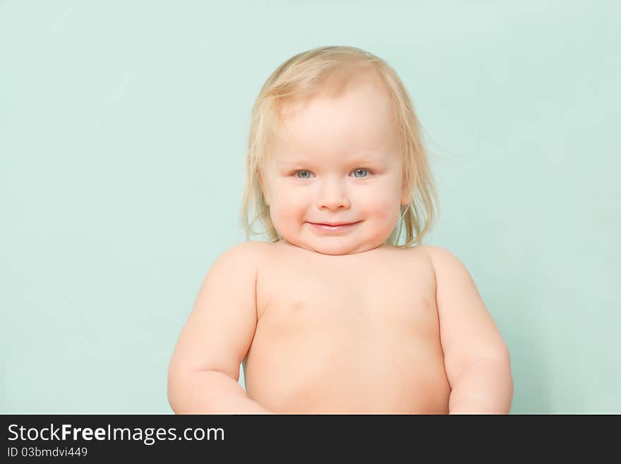 Adorable happy baby stay in kitchen after lunch