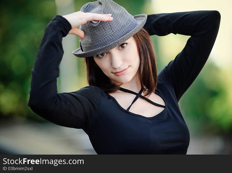 The beautiful girl holds a hat. The beautiful girl holds a hat