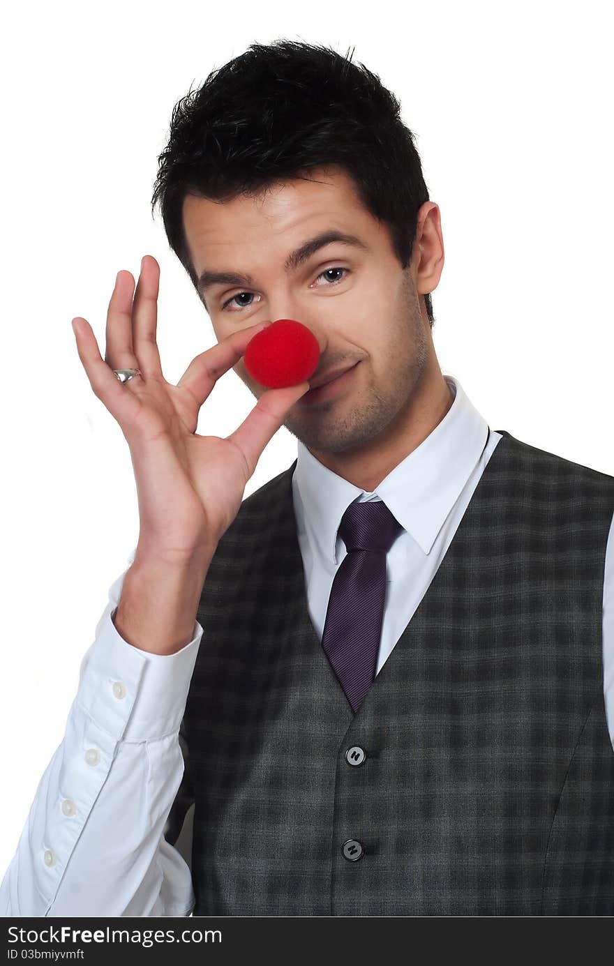 Young man magican making clown nose isolated on white