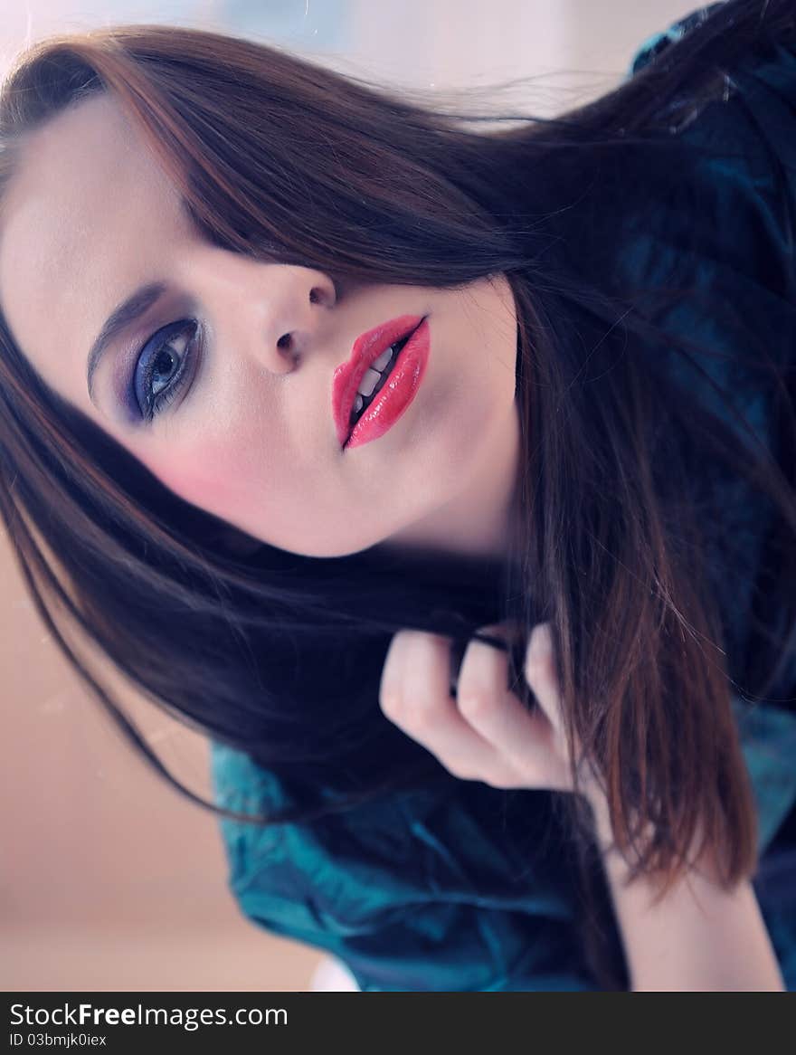 Beautiful model woman face with fashion make-up in violet tones