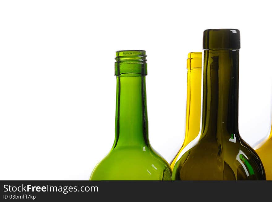 Many empty green wine bottles isolated on white background