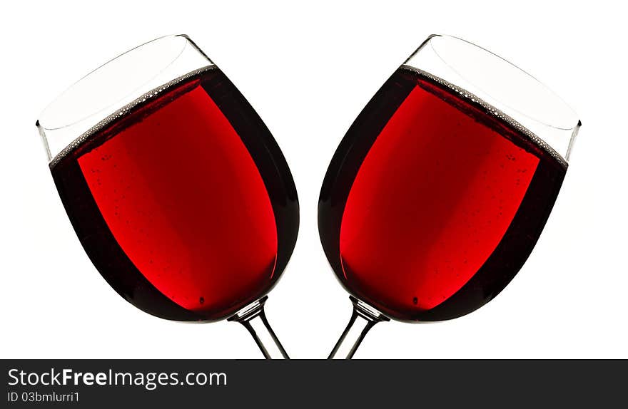 Close up of two glasses of red fruit juice on a white background