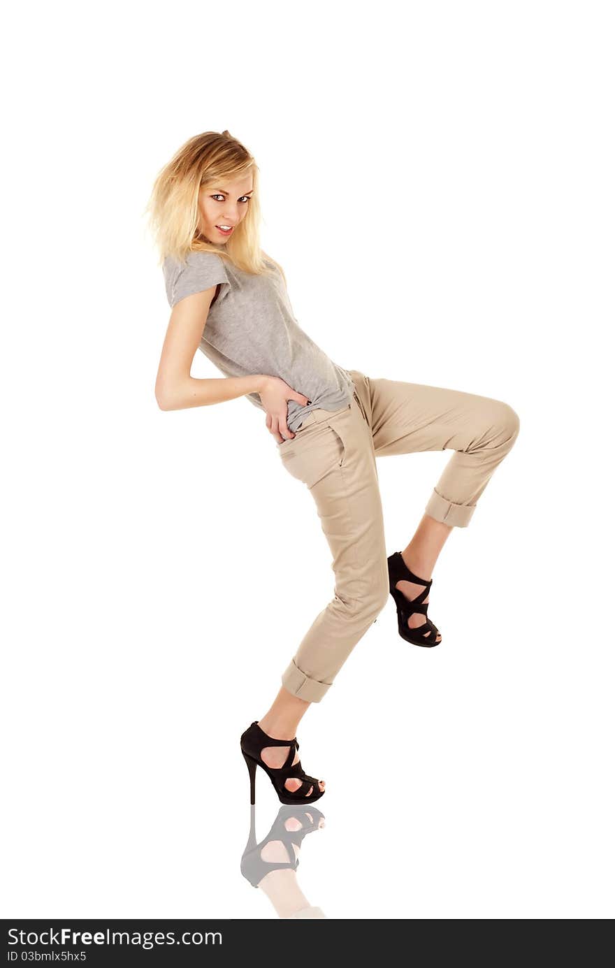 Portrait of beautiful young woman dancing against white background