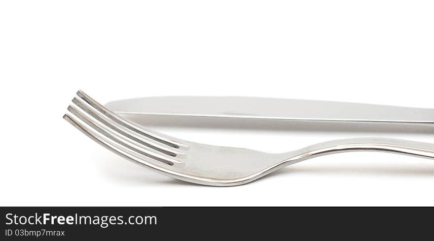 Close up of a knife and fork on white background