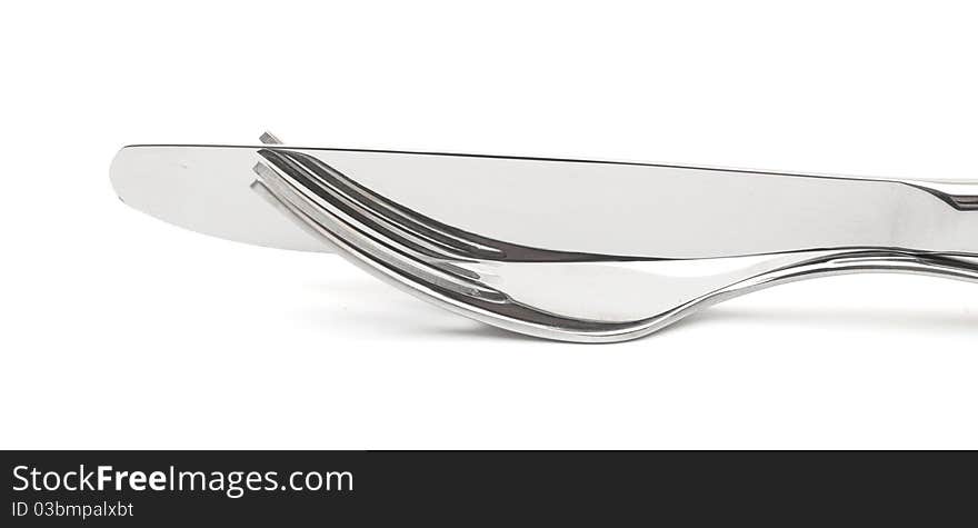 Close up of a knife and fork on white background