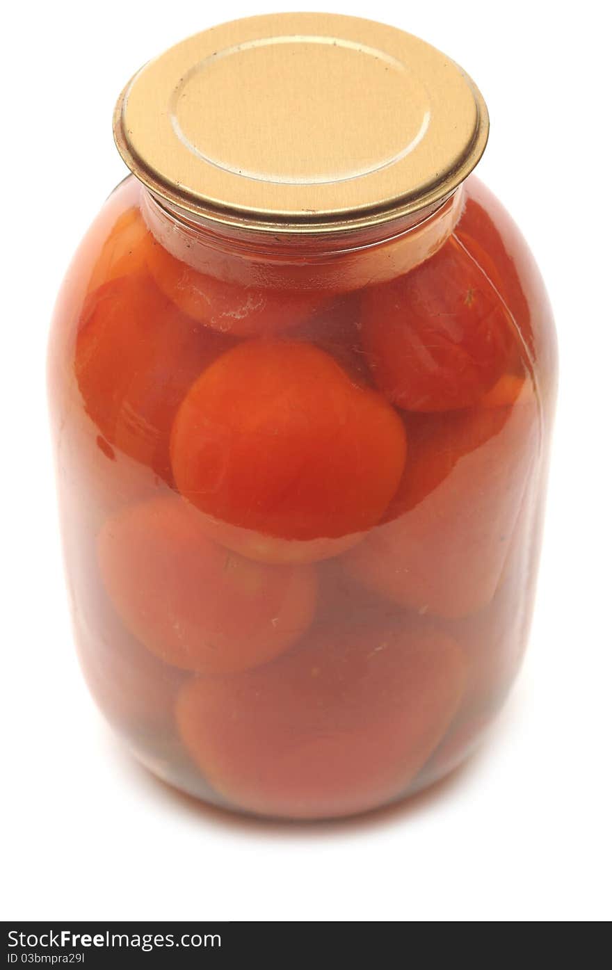 Tomatoes vegetables canned in glass jars on white