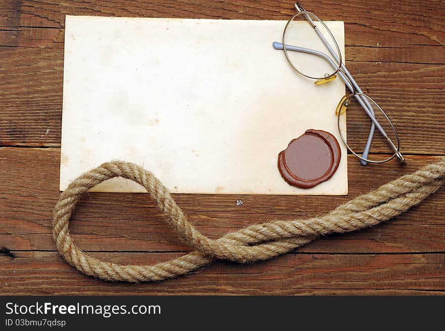 Old paper with a wax seal on a wood background