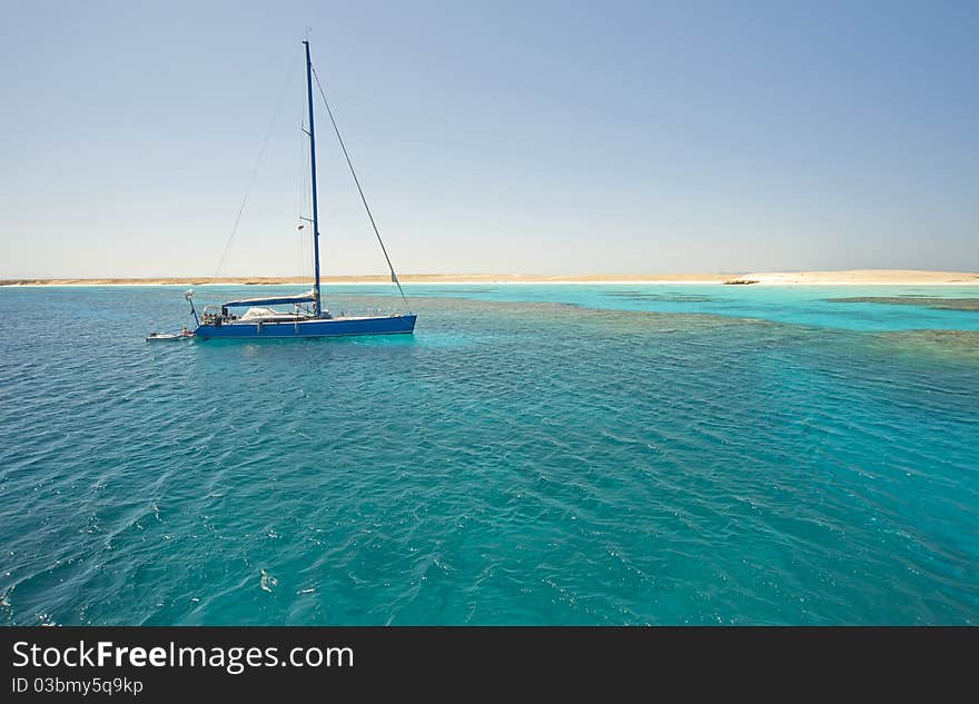 Large sailing yacht in a tropical lagoon