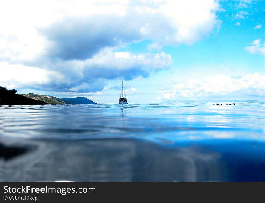 Ship Floating on Lake Under Sunny Blue Sky. Ship Floating on Lake Under Sunny Blue Sky