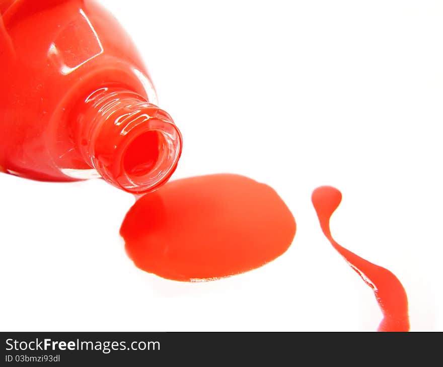 Red pouring nail polisher isolated on white