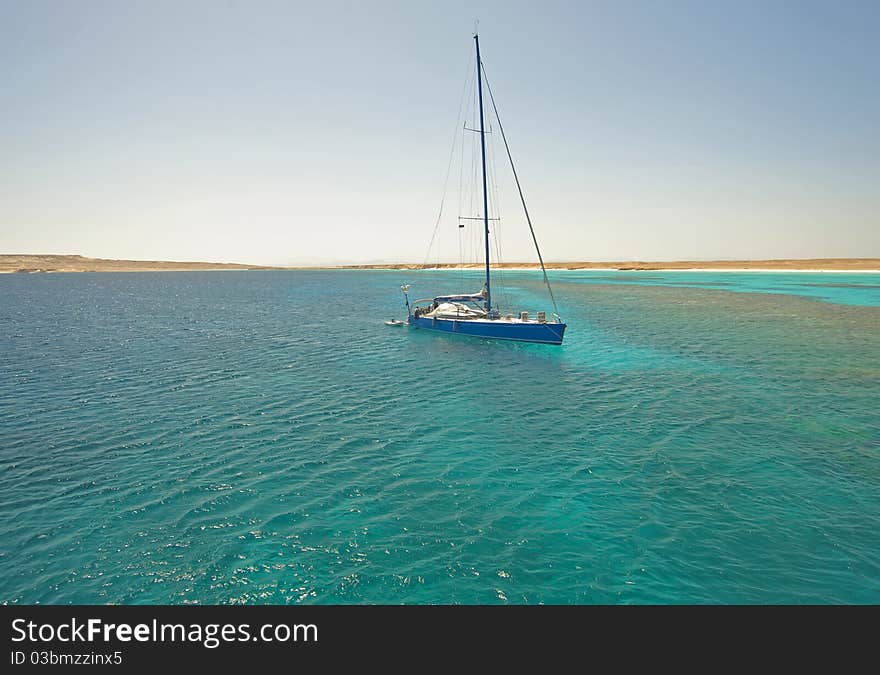 Large sailing yacht in a tropical lagoon