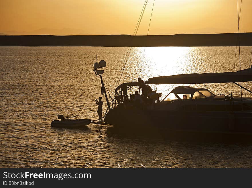 Private sailing yacht silhouetted at sunset whilst at anchor. Private sailing yacht silhouetted at sunset whilst at anchor