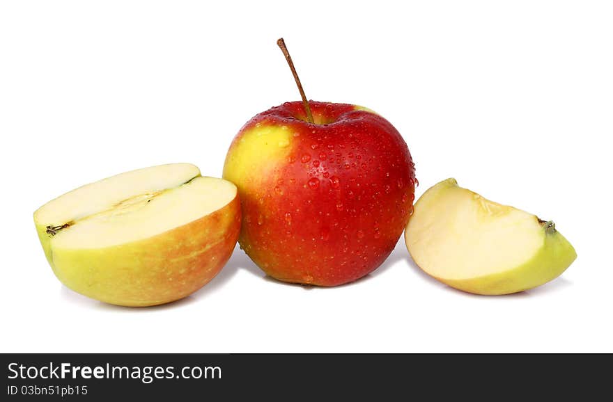 Cut apple is in drops isolated on white background