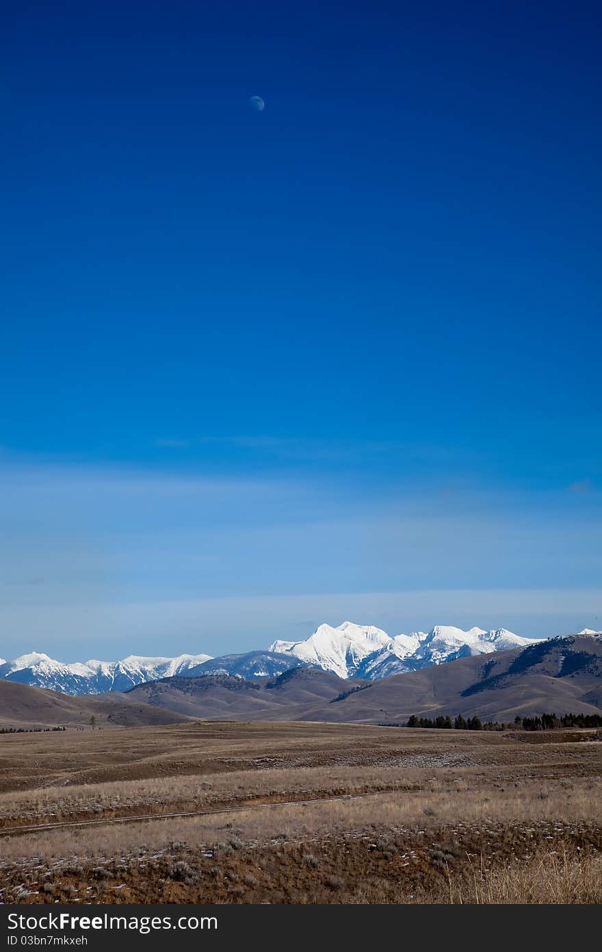 Mission Mountains Landscape with the moon still high in the sky, taken in February. Mission Mountains Landscape with the moon still high in the sky, taken in February