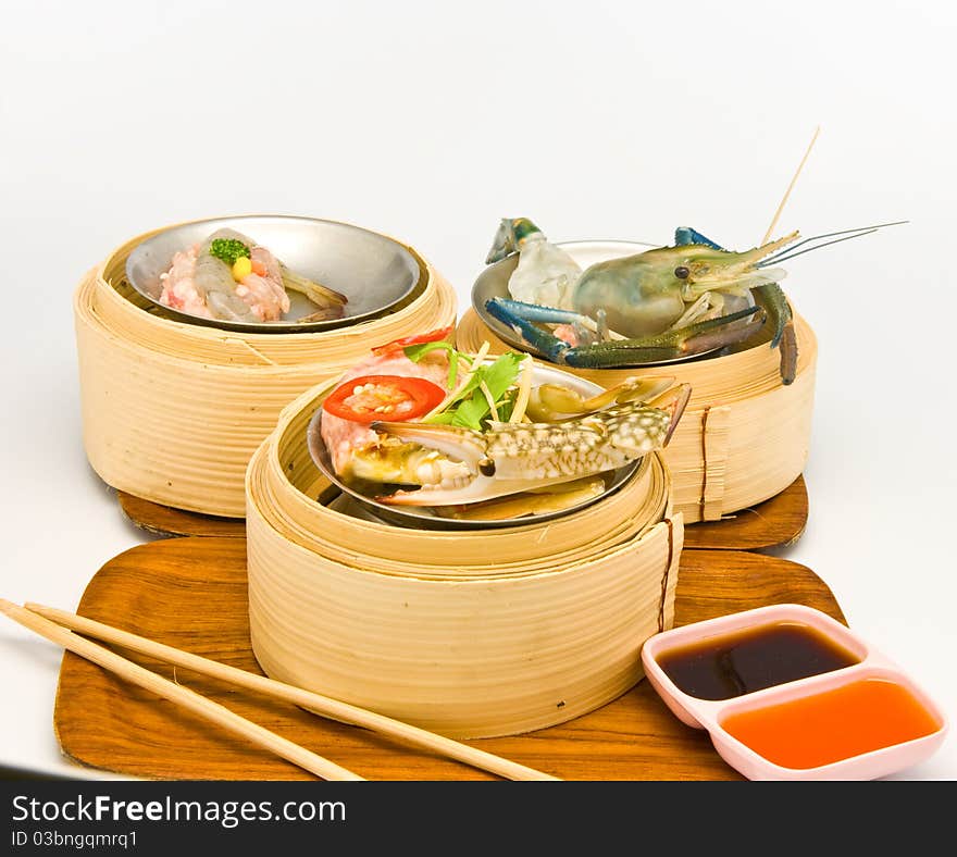 Chinese steamed seafood dimsum in bamboo containers traditional cuisine. Chinese steamed seafood dimsum in bamboo containers traditional cuisine