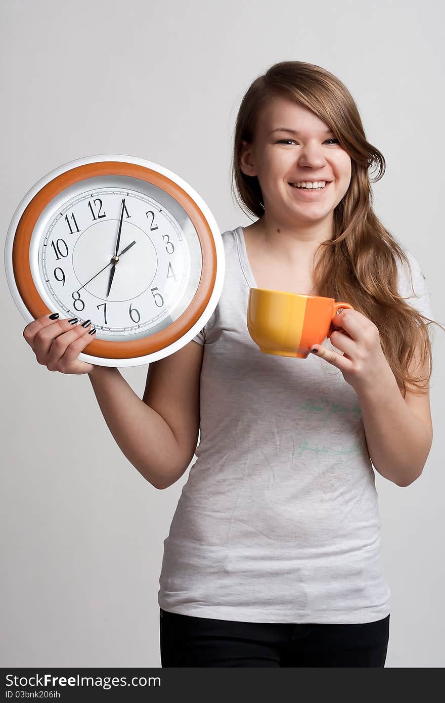 Portrait of a girl with a cup and a clock