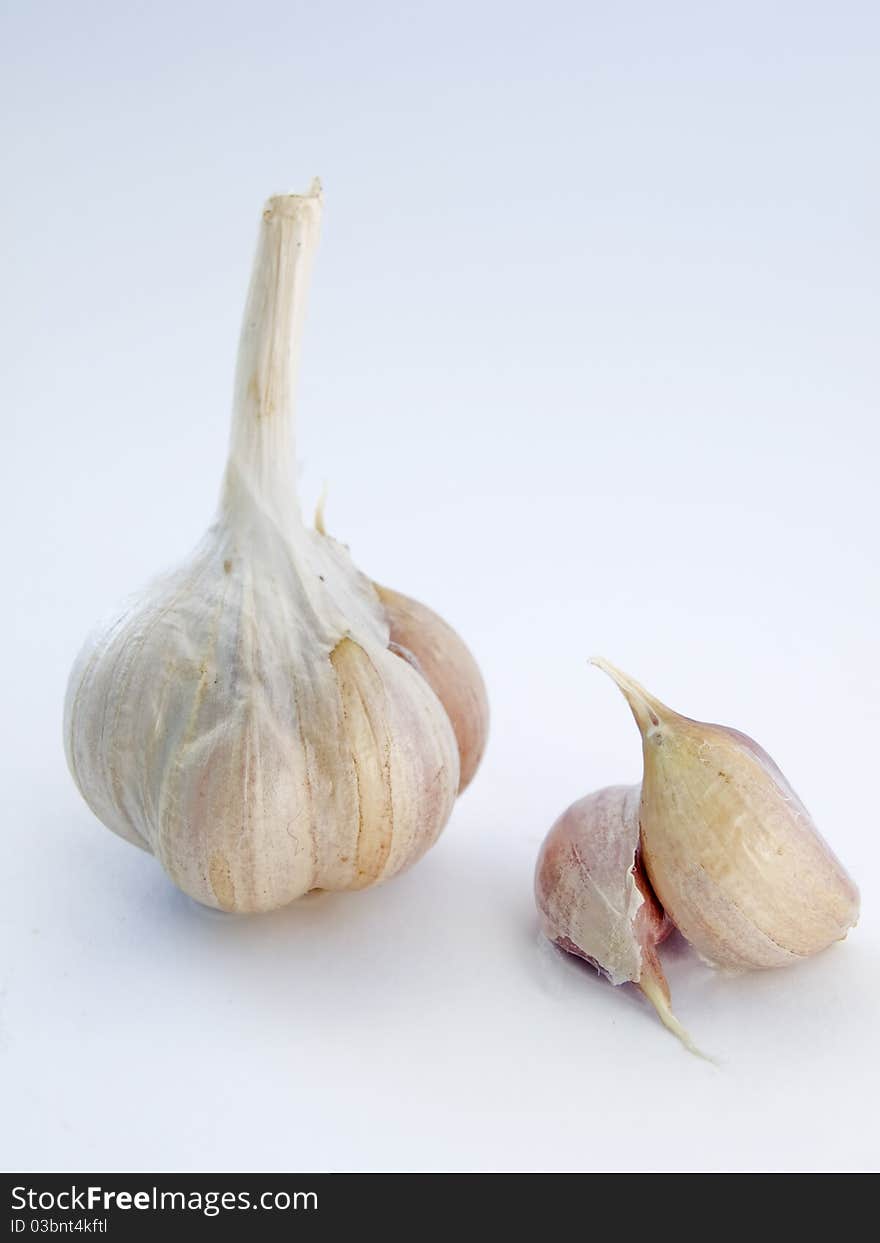 Head and the cloves of garlic isolated on white