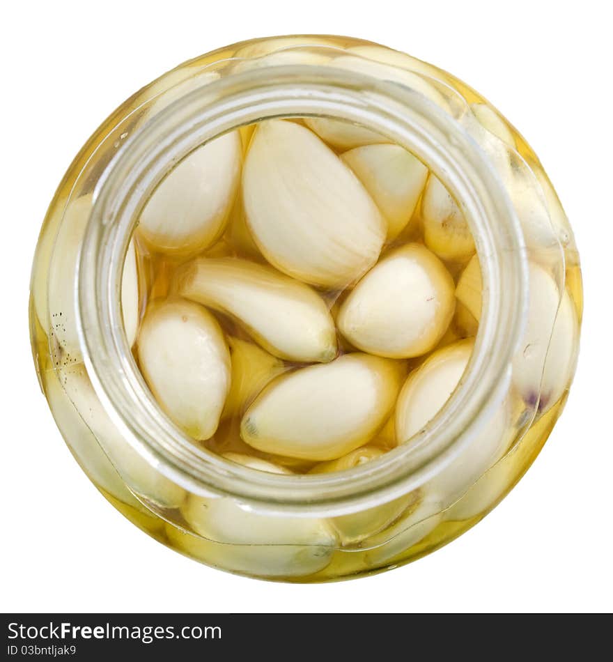 Cloves of garlic in the pot with sunflower oil isolated on white