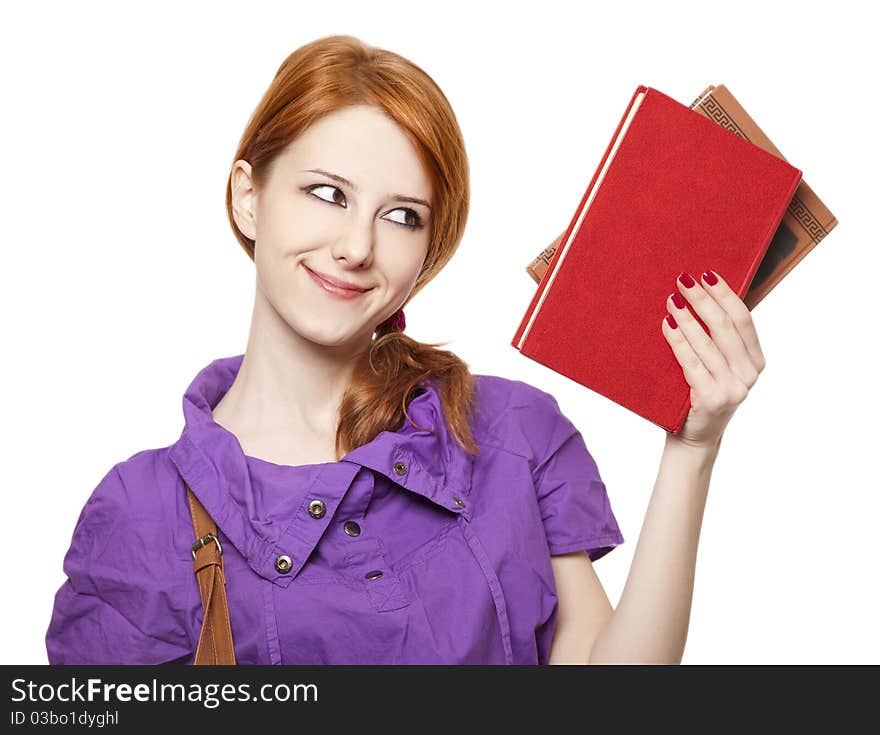 Red-haired girl keep book in hand. Studio shot.