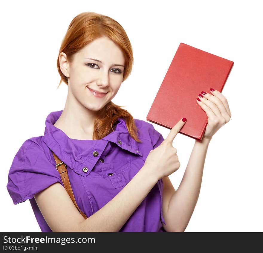 Red-haired girl keep book in hand. Studio shot.