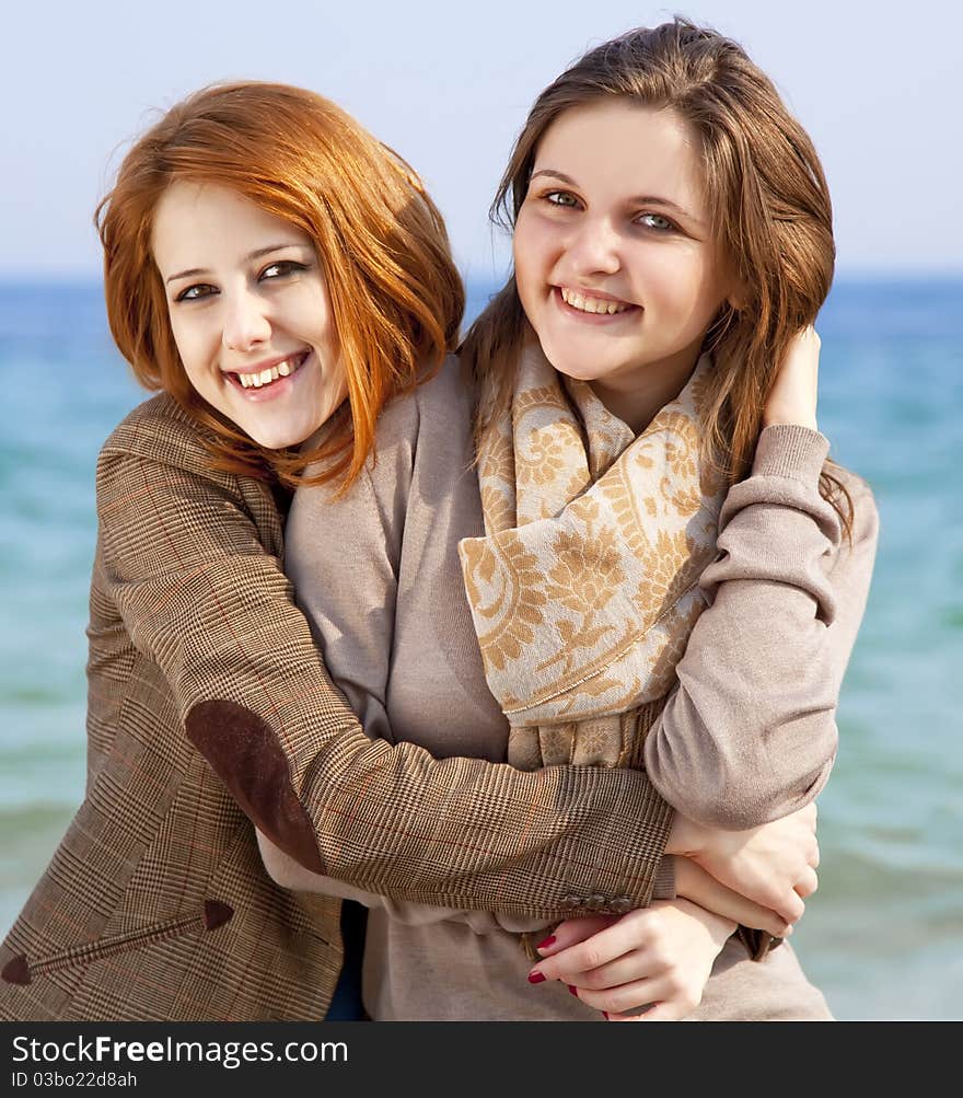 Two happy girls at spring beach.